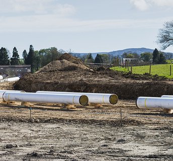 EMC Constuction site with pipes fisher german banner